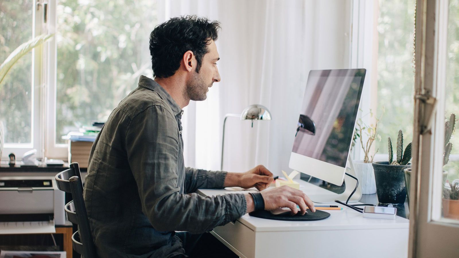 Man sitzt vor einem Computer Bildschirm