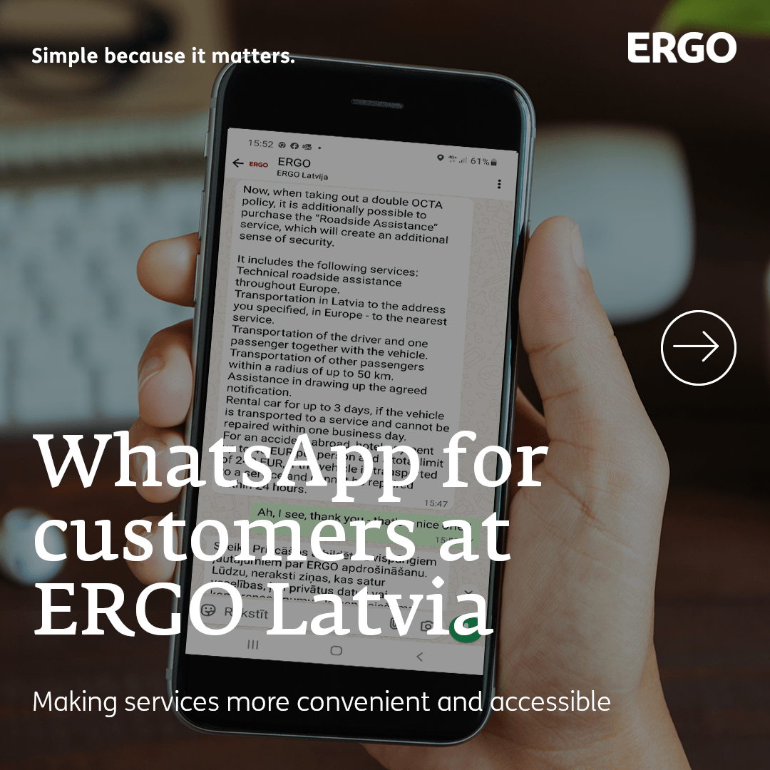 A hand with a mobile phone showing a WhatsApp conversation.