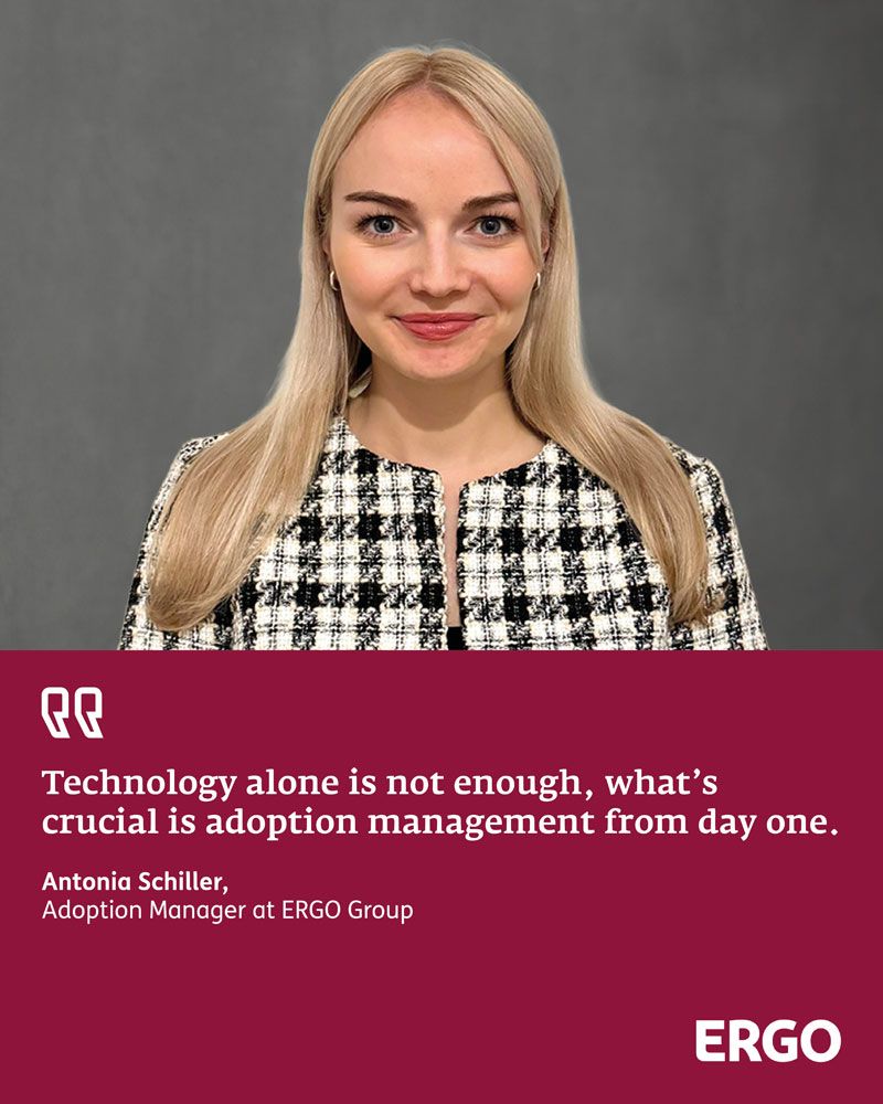 Young blonde woman wearing a black-and-white blazer against a grey background
