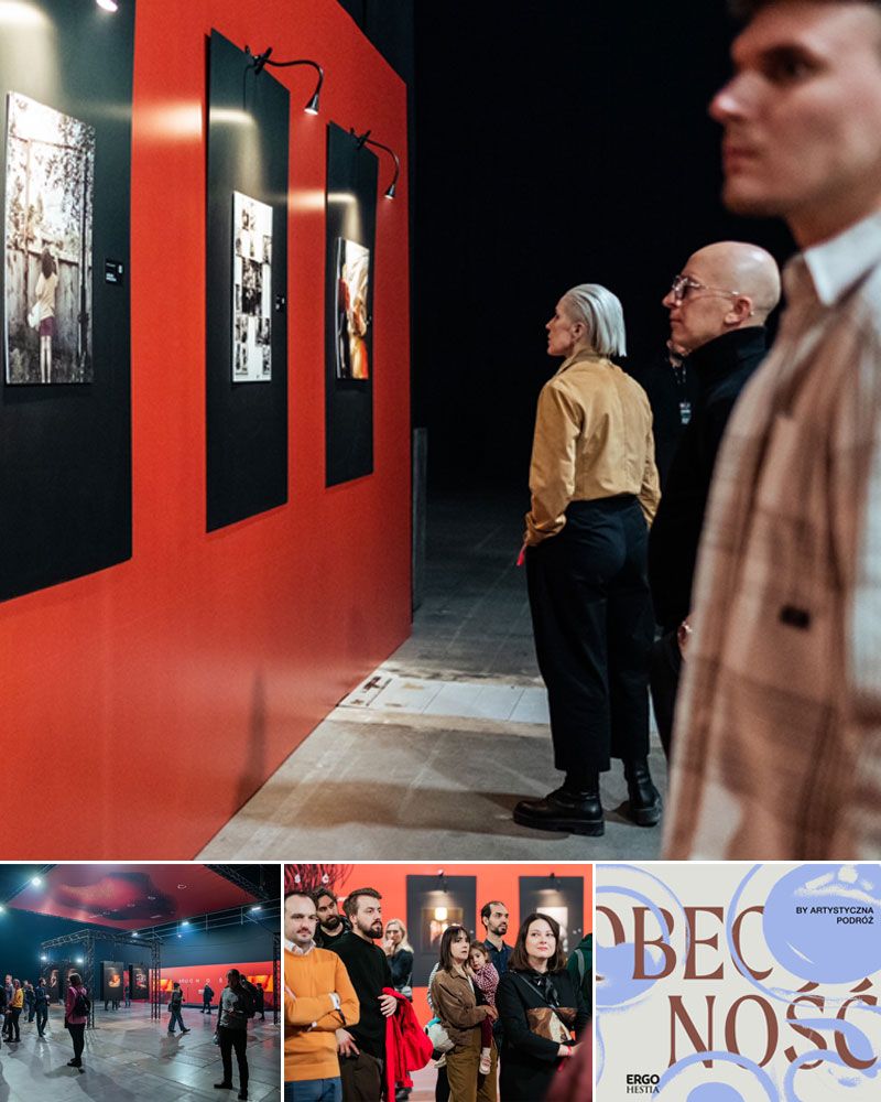 Three people observe illuminated pictures on a red wall in an exhibition space.