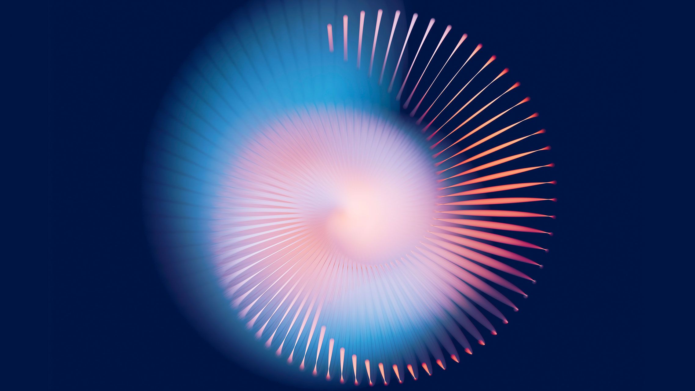 Kreisförmiges Lichtspiel aus hellblau, rosa und orange auf einem dunkelblauen Hintergrund.