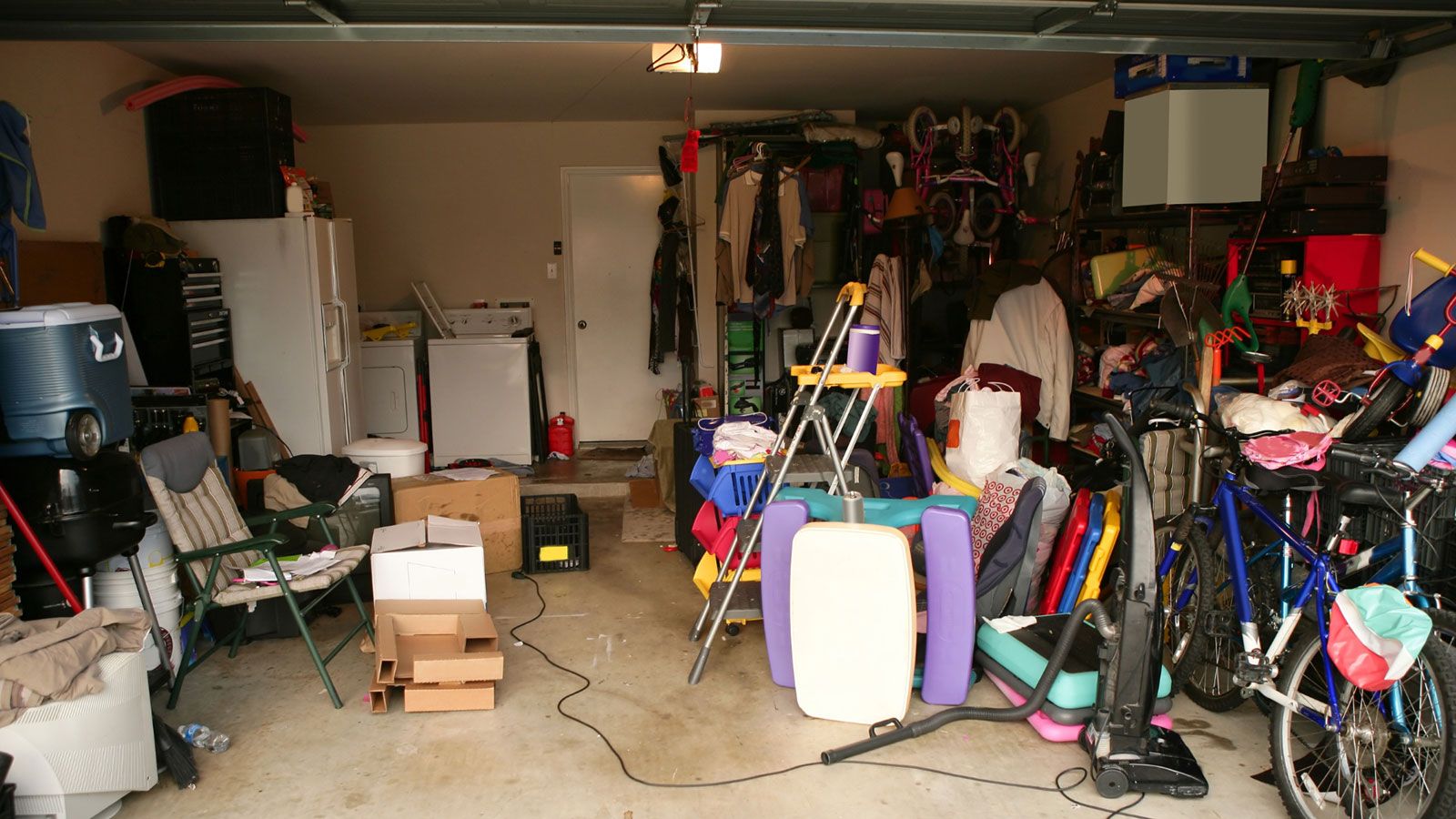 Interior view of a garage with a bicycle and other storage items.